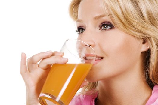 Closeup portrait of a lovely blonde drinking fresh juice 