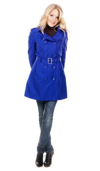 Pretty model in a blue coat against white background 