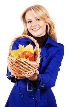 Portrait of lovely woman with a basket of ripe fruit 