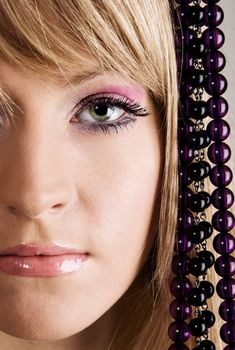 Beautiful young woman with beads studio photo