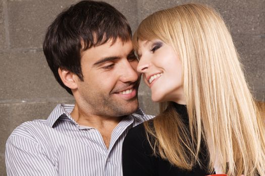 Young romantic couple kissing in house interior