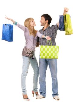 Beautiful young couple with shopping bags, isolated on white background 