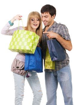 Beautiful young couple with shopping bags, isolated on white background