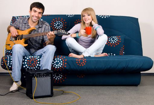 Cheerful couple resting on a sofa