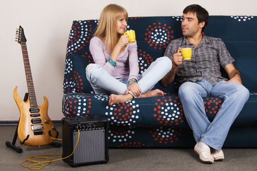 Cheerful couple resting on a sofa