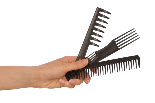 hairdresser holds the black tools for haircut