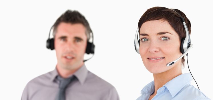 Close up of managers using headsets against a white background