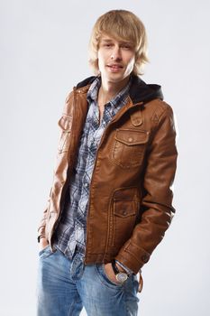 Handsome young man in leather jacket, studio portrait