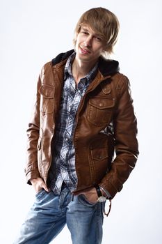 Handsome young man in leather jacket, studio portrait