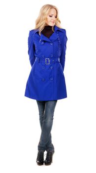 Pretty model in a blue coat against white background 