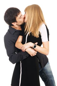 Young elegant couple is kissing against white background