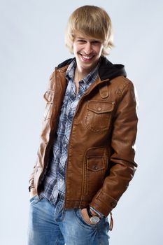 Handsome young man in leather jacket, studio portrait