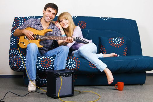 Cheerful couple resting on a sofa