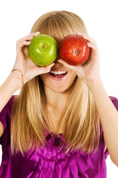Funny girl holding two apples in front of her eyes