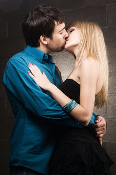 Young romantic couple kissing in house interior 
