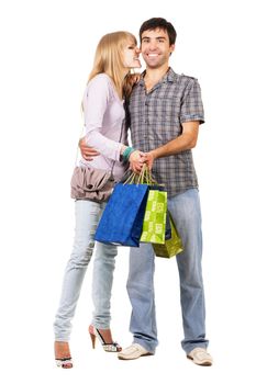 Beautiful young couple with shopping bags, isolated on white background