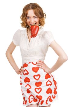 Young beautiful woman holding a paprika in her teeth, white background