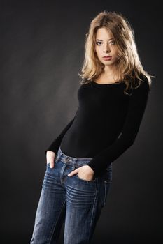 Elegant model in casual clothing against black background 