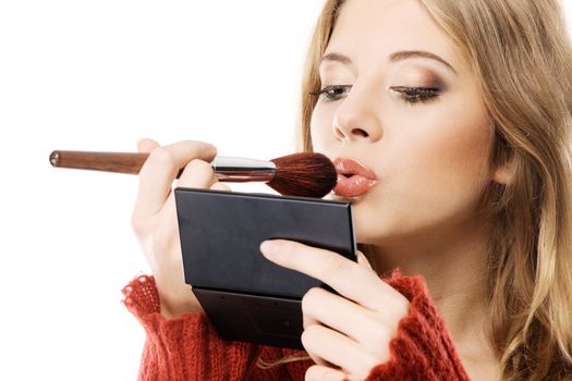 Young pretty woman applying makeup