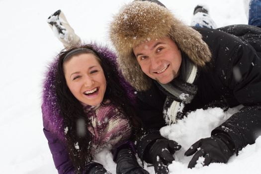 Portrait of young couple having fun in winter park