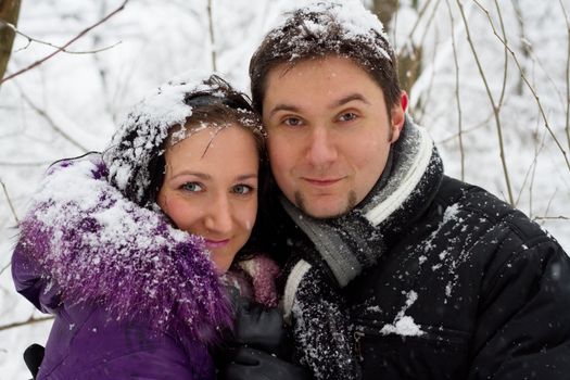 Portrait of a young sweet couple in winter park