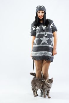 Young lady with a cat, studio photo on neutral backgrund