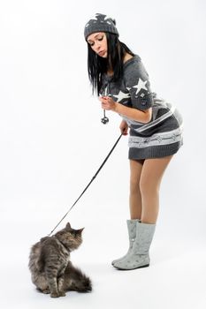 Young lady with a cat, studio photo on neutral backgrund