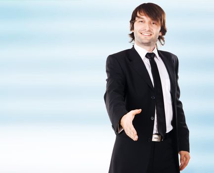 Young elegant businessman reaching open hand, white background 