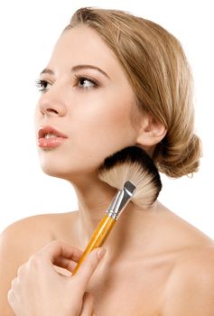 Closeup portrait of a beautiful young woman applying makeup