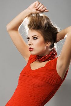 Extravagant model in red gown and necklace 