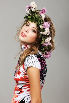 Portrait of a beautiful fashion model in flower crown 