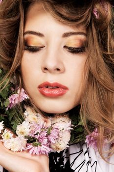 Closeup face portrait of a beautiful woman with aster flowers 