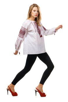 Fashionable model in a traditional slavic shirt, white background