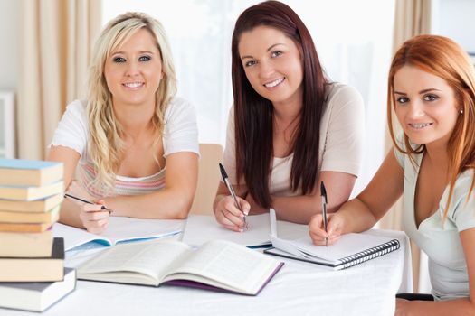 Charming Women sitting at a table learning in a kitchen