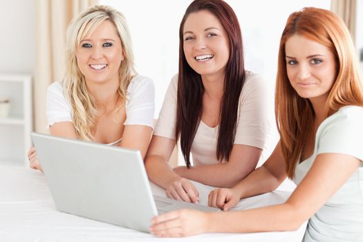 Cute Women sitting at a table with a laptop in a kitchen