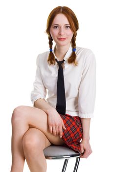 Pretty young woman sitting on a bar chair