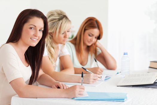 Portrait of charming Students learning at a table in a kitchen