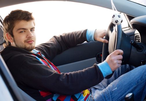 Young man driving his new car