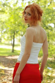 Beautiful young woman having a walk in a park