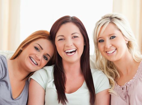 Cheering women sitting on a sofa in the living room