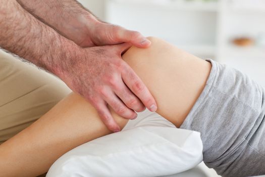 Man massaging a woman's knee in a room