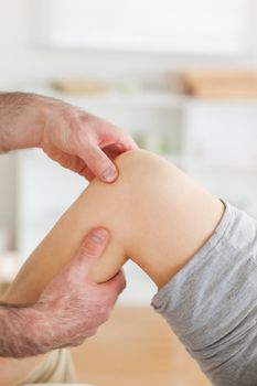 Guy massaging a knee in a room