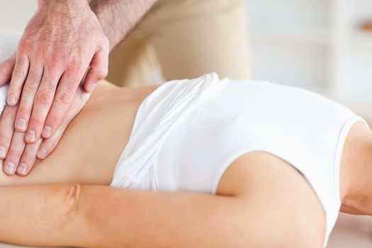 Lying Woman getting a massage in a room