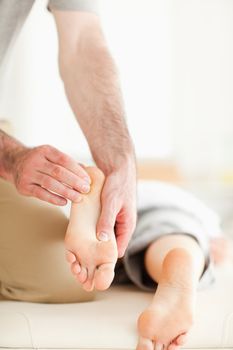 Man massaging a woman's feet in a room