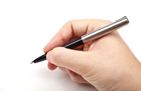 Hand holding a pen in the writing position.