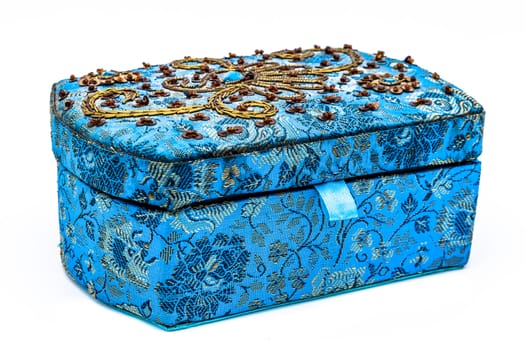 A composition of a blue jewel box on a white background