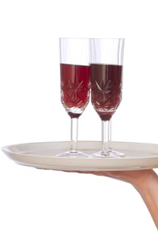 A waiter takes a glass of champagne from a tray with two glasses