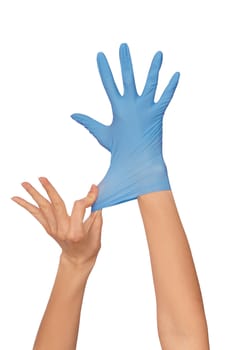 Doctor putting on blue sterilized medical glove for making operation