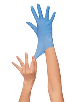 Doctor putting on blue sterilized medical glove for making operation