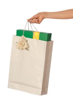 Paper bag with a green box and with a yellow ribbon from the supermarket